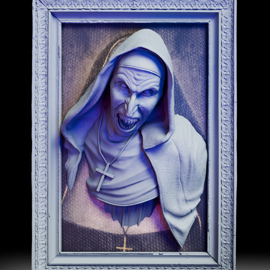 A 180 degree turntable view of the Valak wall portrait bust kit showing the snarling face, hooded habit textures, cross necklace, and the ornate frame as the piece rotates for a full view of the sculpt and frame depth.
